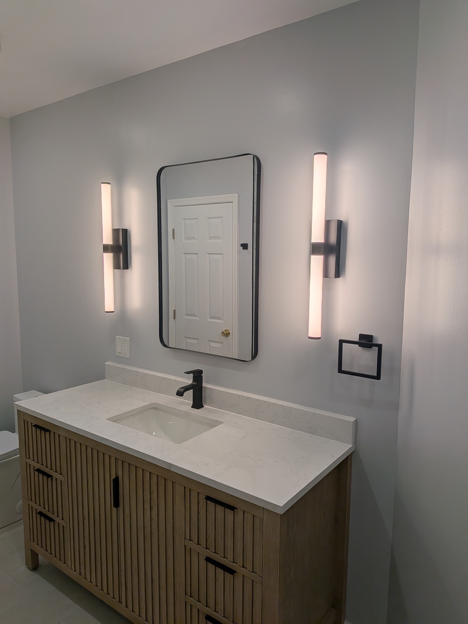 Detail of the backlit shower niche in matte black